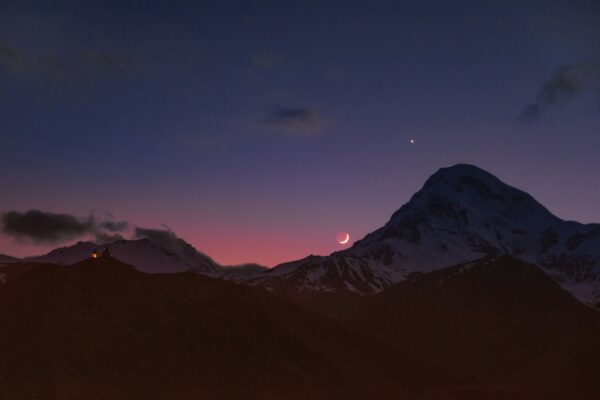 Panoramic view of Mount Kazbek and the Caucasus mountains at twilight in Kazbegi, Georgia